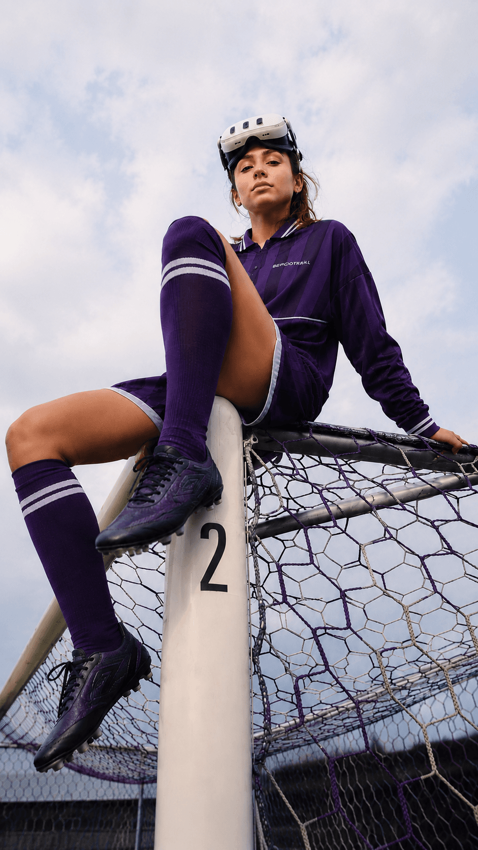 Player resting against a goalpost